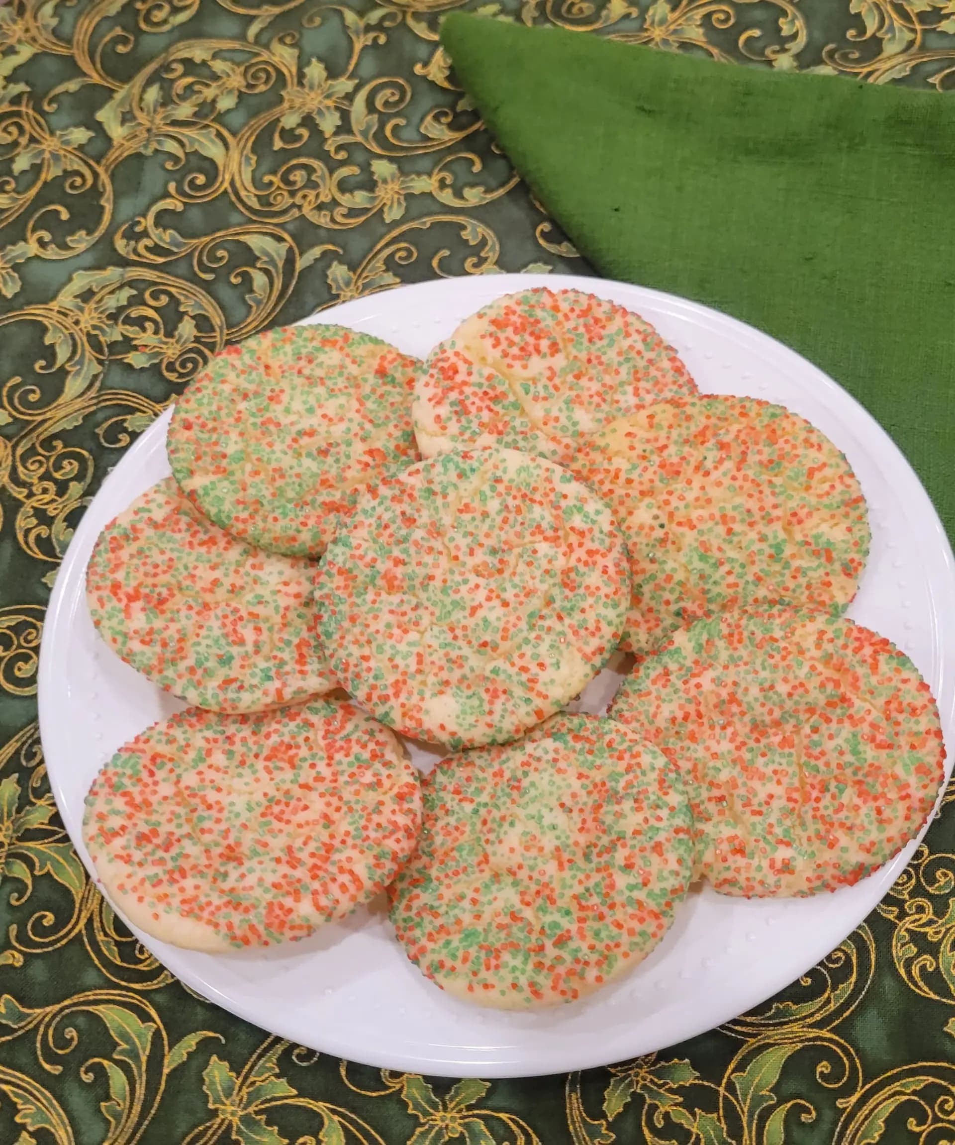 A plate of sprinkled cookies on a table