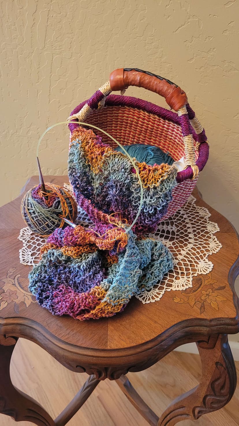 A crocheted basket sitting on top of a wooden table