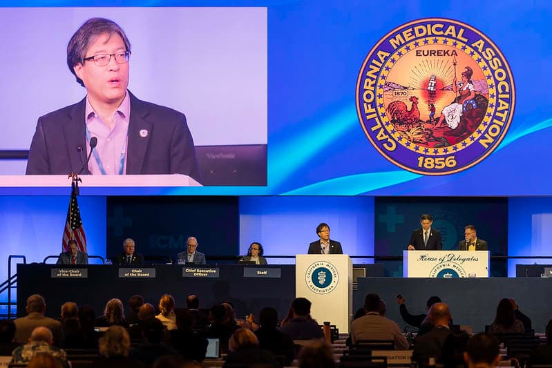 A man standing at a podium in front of a crowd